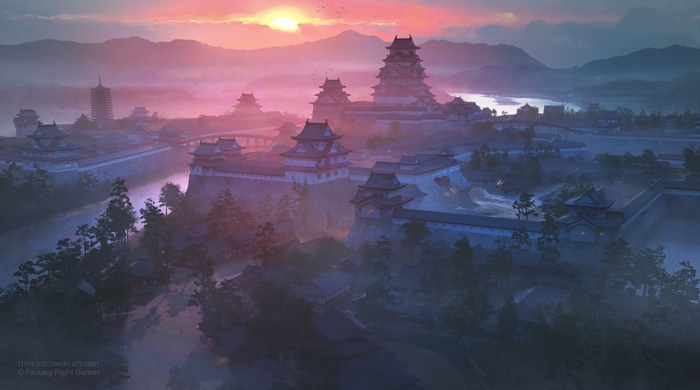 Japanese castle town at sunset with mountains