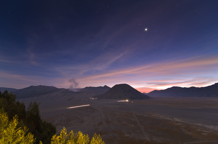 Bromo Volcano at twilight with stars and light trails