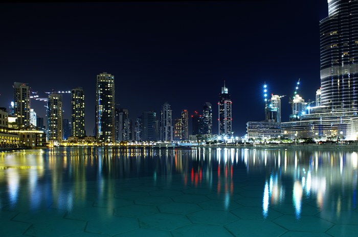 4K Dubai cityscape at night with water reflection