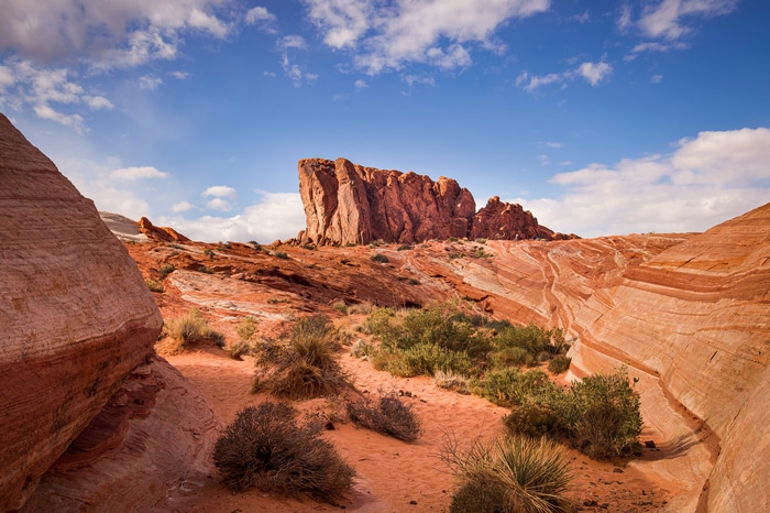 Red rock formations and desert landscape under a blue sky