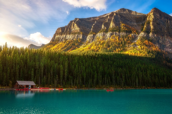 Turquoise lake with a boathouse and mountains