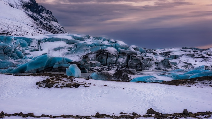 Glacier landscape with blue ice and snowy mountain