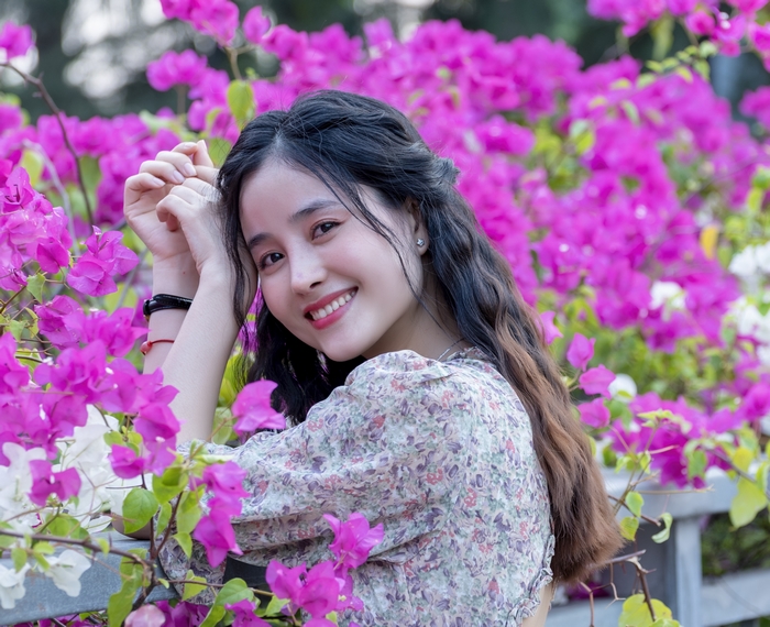 Asian Woman Smiling Among Pink Flowers