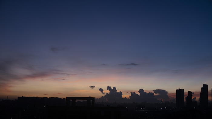 Cityscape at dusk with colorful clouds
