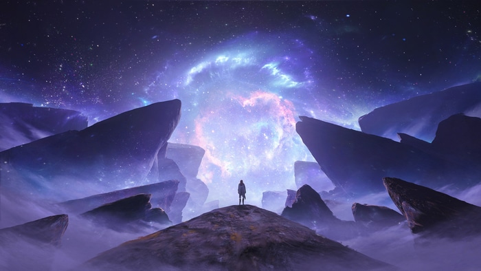 Man standing on a mountain looking at a galaxy