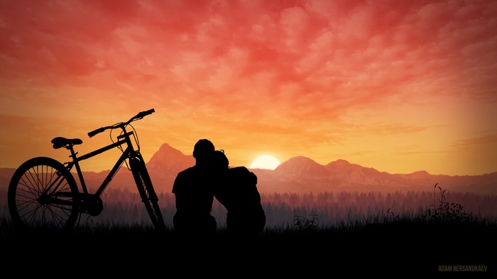Couple watching sunset with bicycle