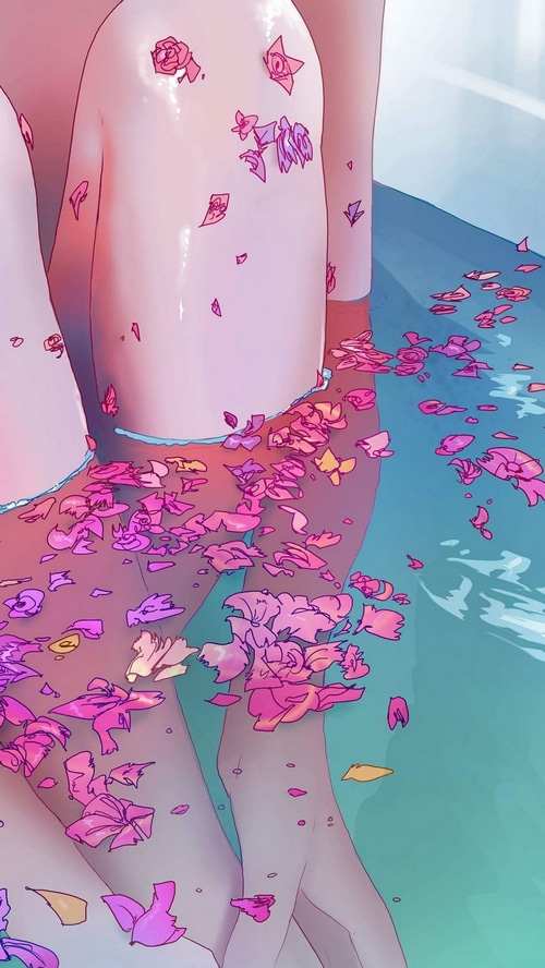 Legs in a bathtub with flower petals