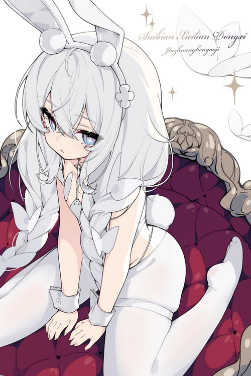 Le Malin in a bunny suit kneeling on a couch
