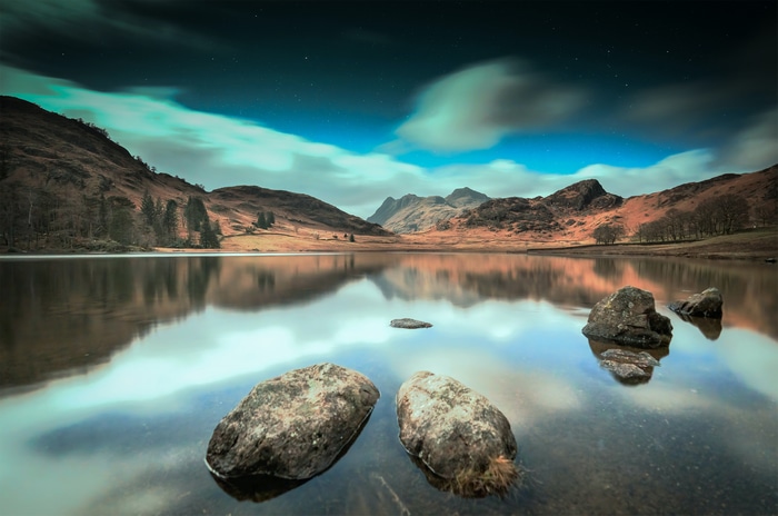 Mountains reflected in a lake at night