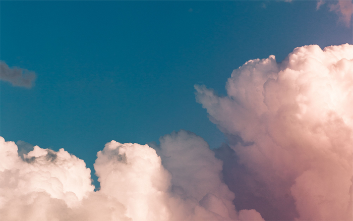 Pink and white clouds against a blue sky