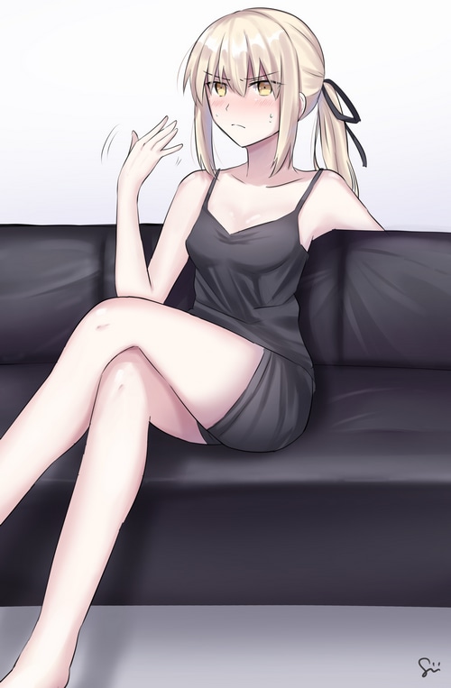Saber Alter in a black dress on a couch