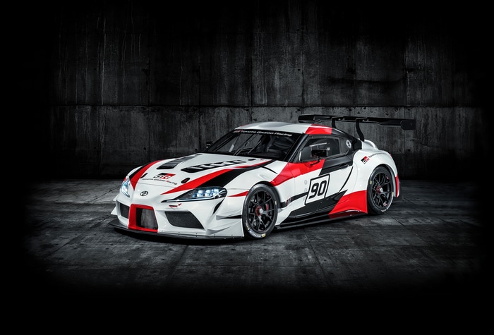 Toyota GR Supra GT4 race car with white, red, and black livery
