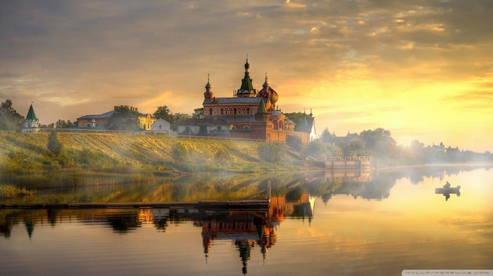 Church reflection on the river at sunrise in Russia