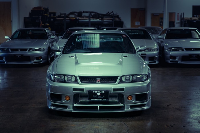 Silver Nissan Skyline R33 cars in a garage