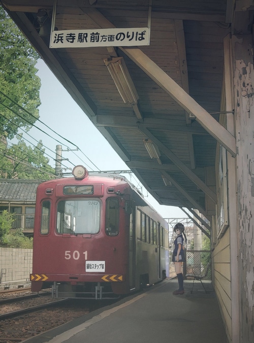 A girl waits for a train at a station