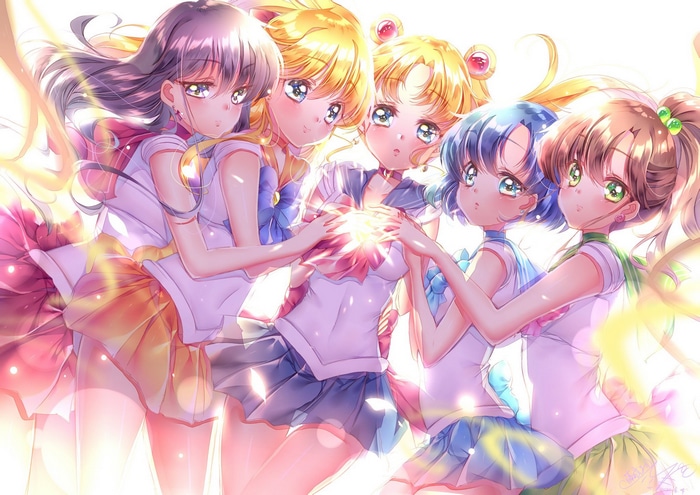 Sailor Moon characters holding a glowing light