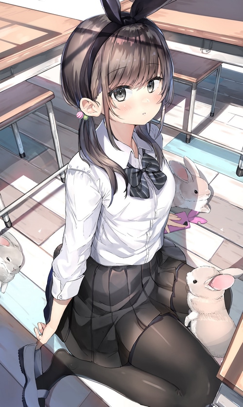 Girl with bunny ears and rabbits in a classroom