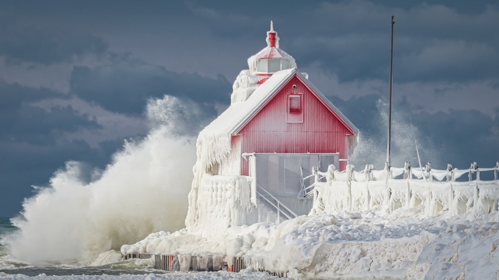 Frozen red lighthouse in a winter storm