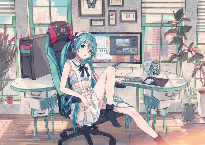 Hatsune Miku sitting at a computer desk