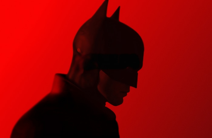 4K Batman in front of red background