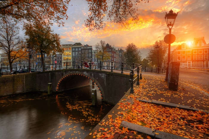 Amsterdam canal bridge at sunset in fall