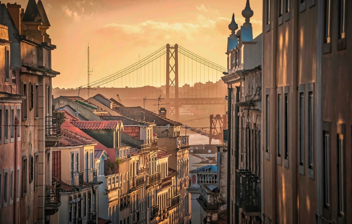 Lisbon cityscape with bridge at sunset