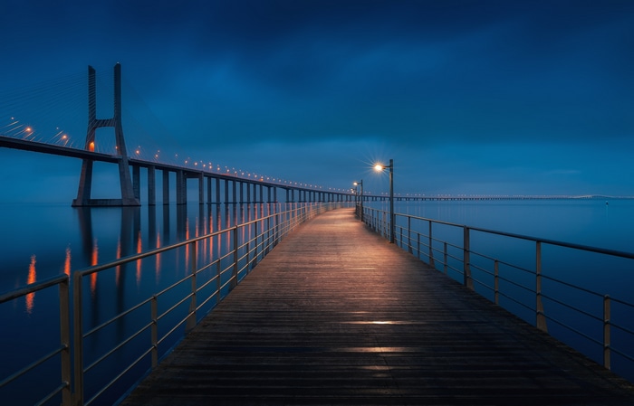 Vasco da Gama Bridge at night with a pier