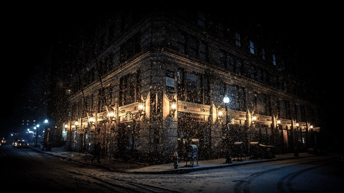 4K snowing night street with building lights