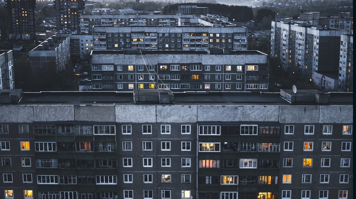 Aerial view of apartment buildings with lights on