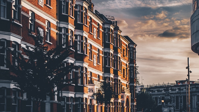 Brick apartments with bay windows at sunset