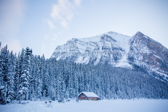 4K Lake Louise winter landscape with snow-covered mountains and cabin