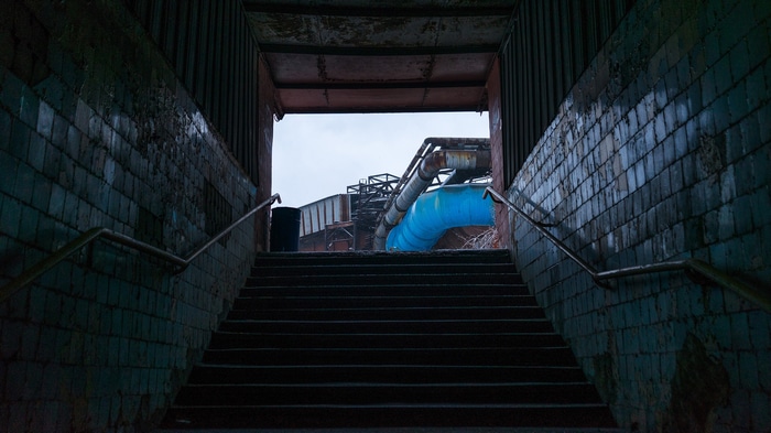 Industrial staircase with blue pipes