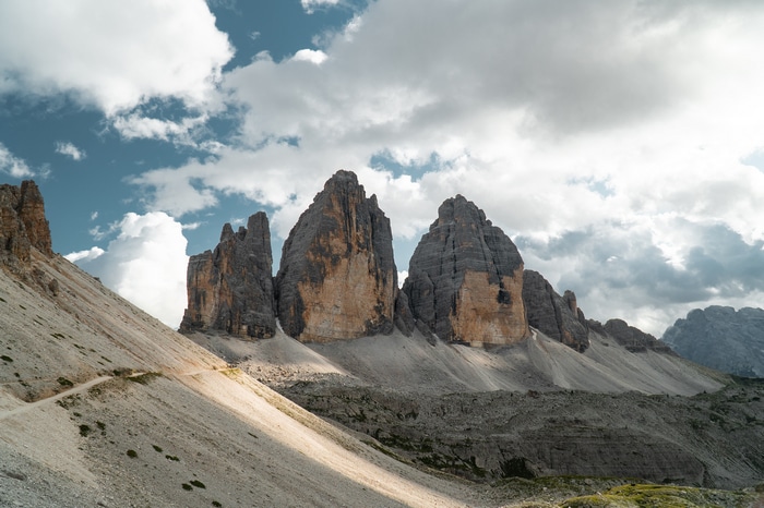 Tre Cime di Lavaredo mountains under cloudy sky