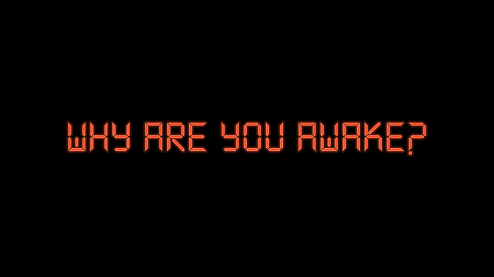Orange digital text WHY ARE YOU AWAKE? on black