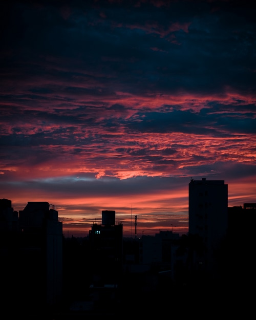 City skyline at sunset with colorful clouds