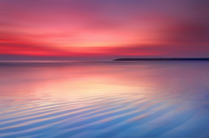 Ocean view at sunset with pink and orange sky
