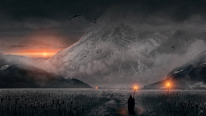 Man with torch walks through field at sunset