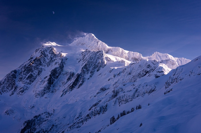 Mount Shuksan in Washington during winter with a crescent moon