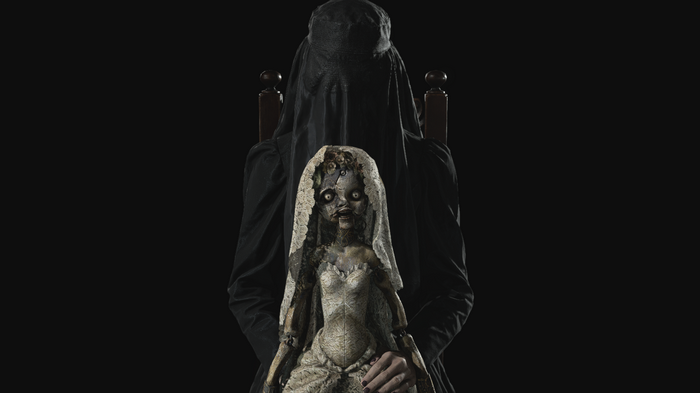Donna Beneviento holding a doll in Resident Evil 8