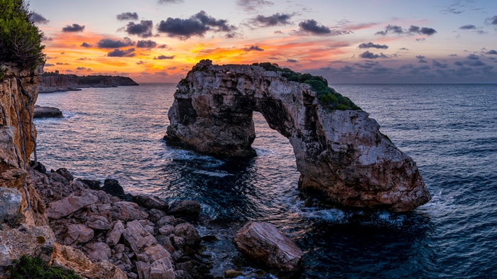 4K Mallorca coast with natural rock arch at sunset