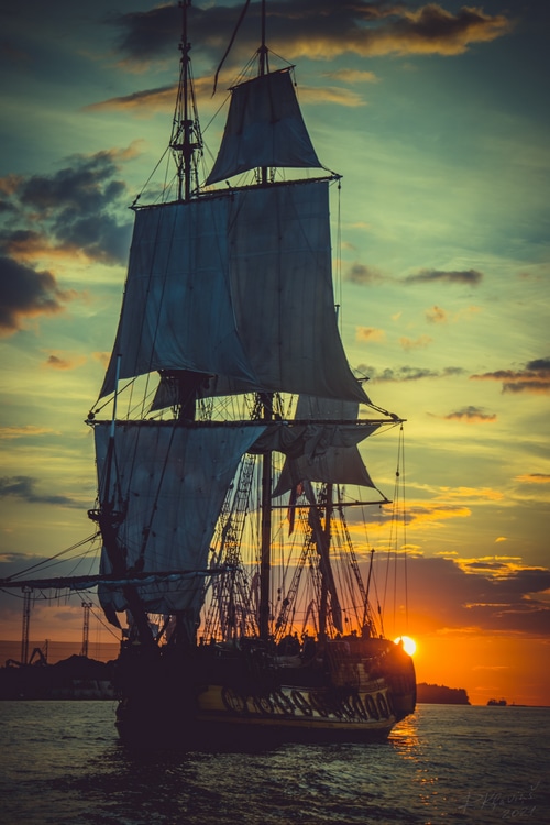 Sailing ship on the sea at sunset