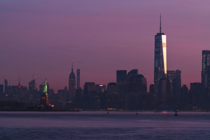 New York City skyline with Statue of Liberty at dusk