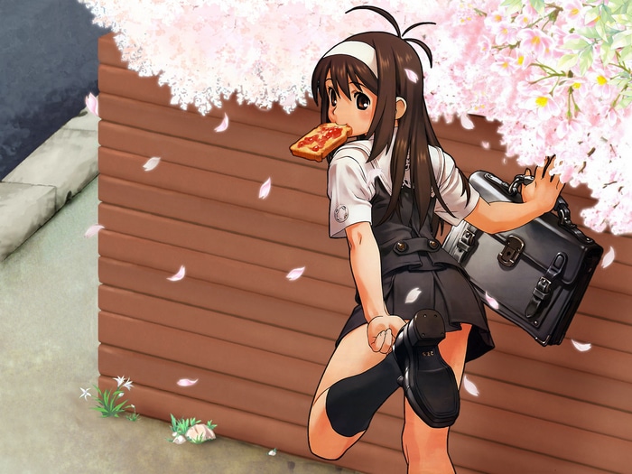 Girl in school uniform eating pizza under cherry blossoms