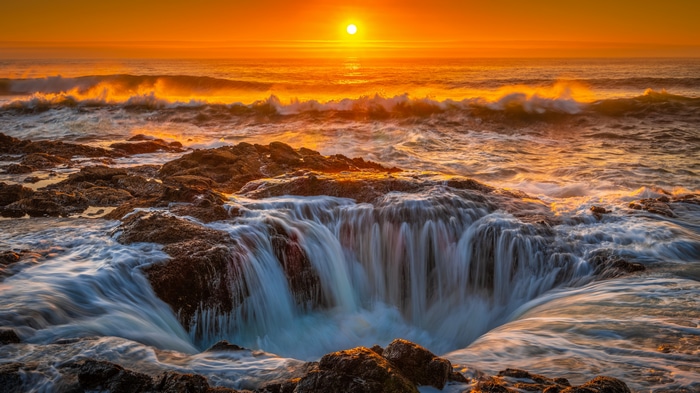 4K sunset over the sea with waves and rocks