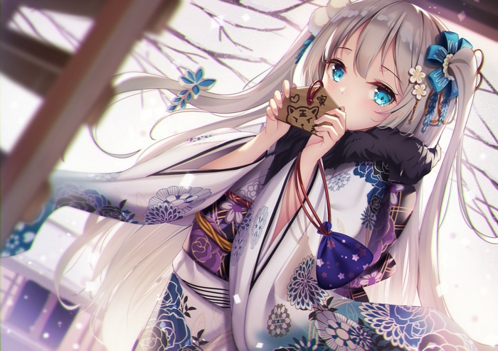 Anime girl in Japanese clothes holding a charm