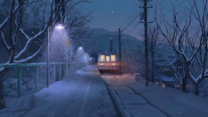 Train at a snowy station at night