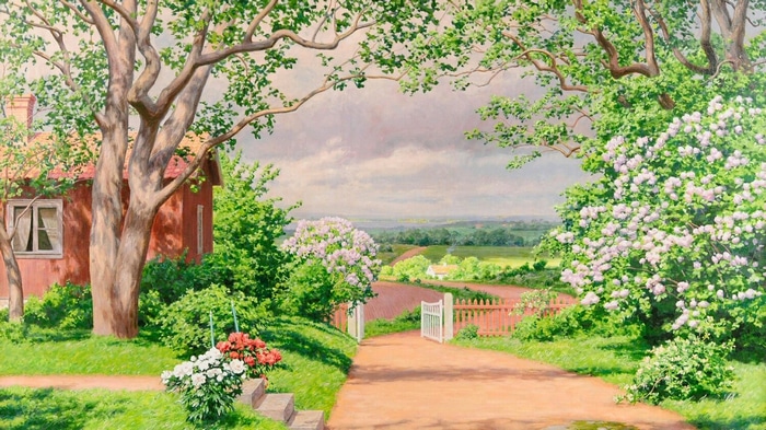 Red house with flowers and trees in a garden