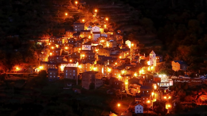 Town illuminated by lights at night