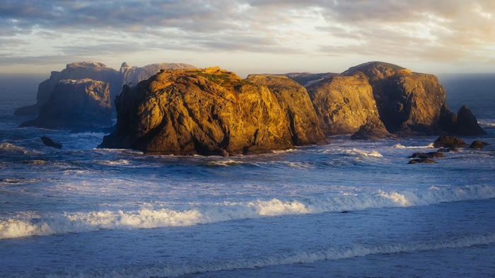 Rocky coastline at Bandon Beach, Oregon during sunset