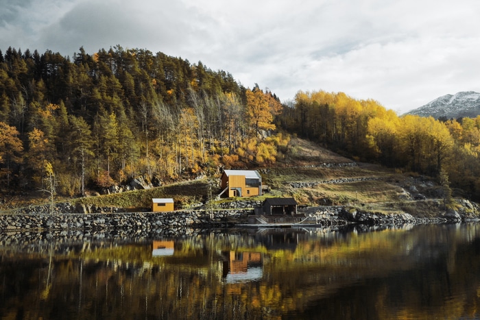 Autumn landscape with houses by the lake